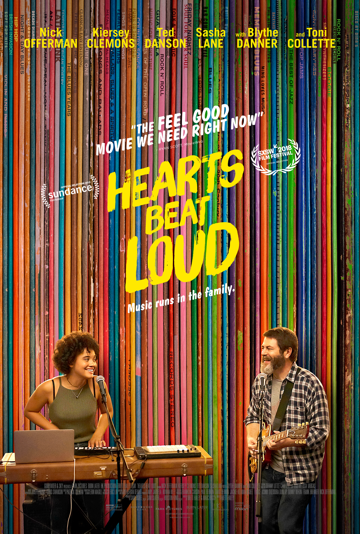 movie poster featuring a young black woman playing keyboard and an older bearded white man playing guitar in front of a rainbow pattern.
